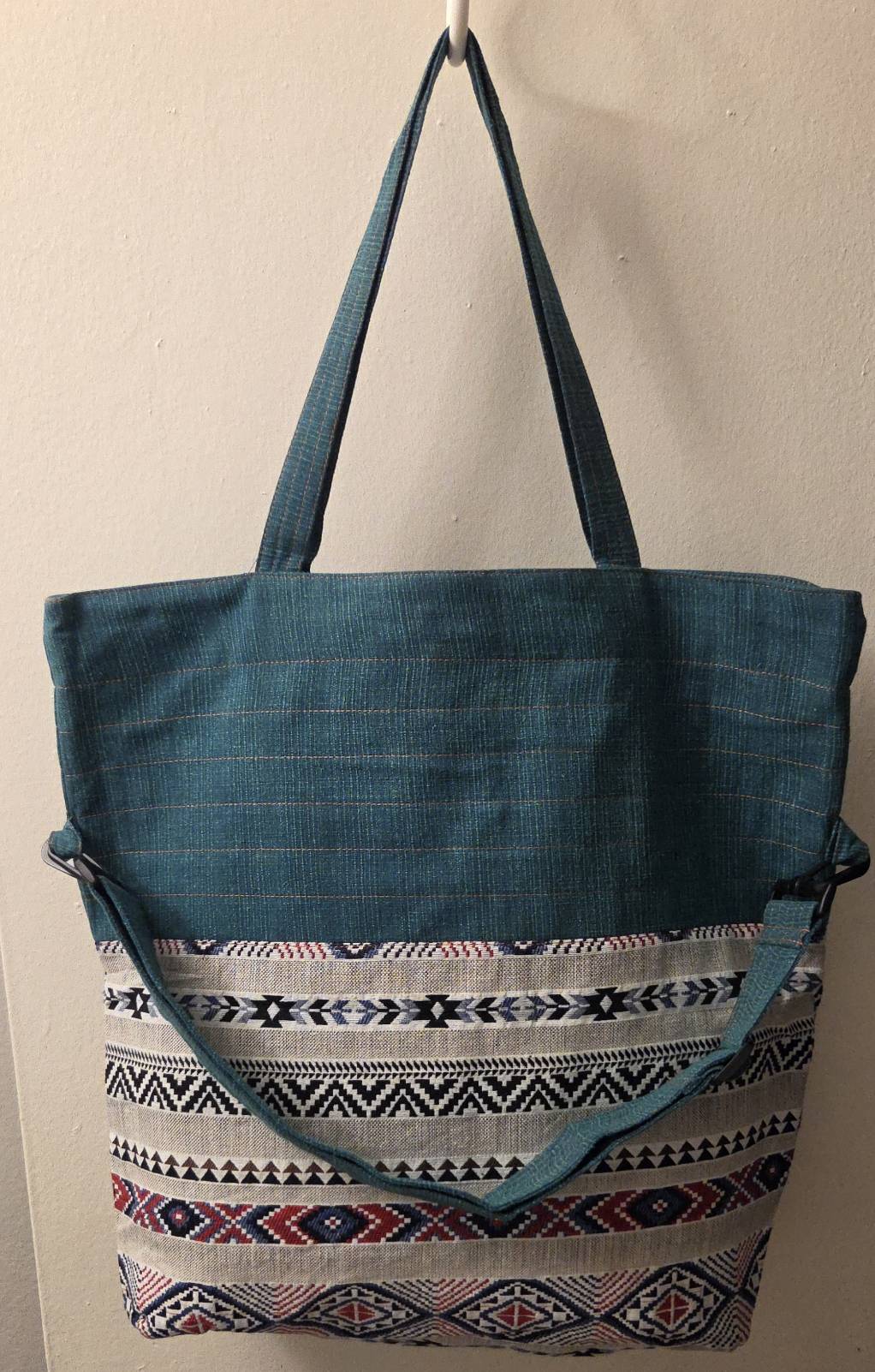 Thai cotton boho tote bag ET-05 – teal body with warm brown aztec diamond woven panel, crossbody strap, lifestyle shot