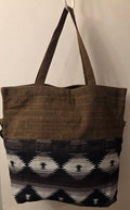 Thai cotton boho tote bag ET-07 – dark brown body with bold brown white geometric aztec woven panel, detachable strap, lifestyle hanging shot with potted plant