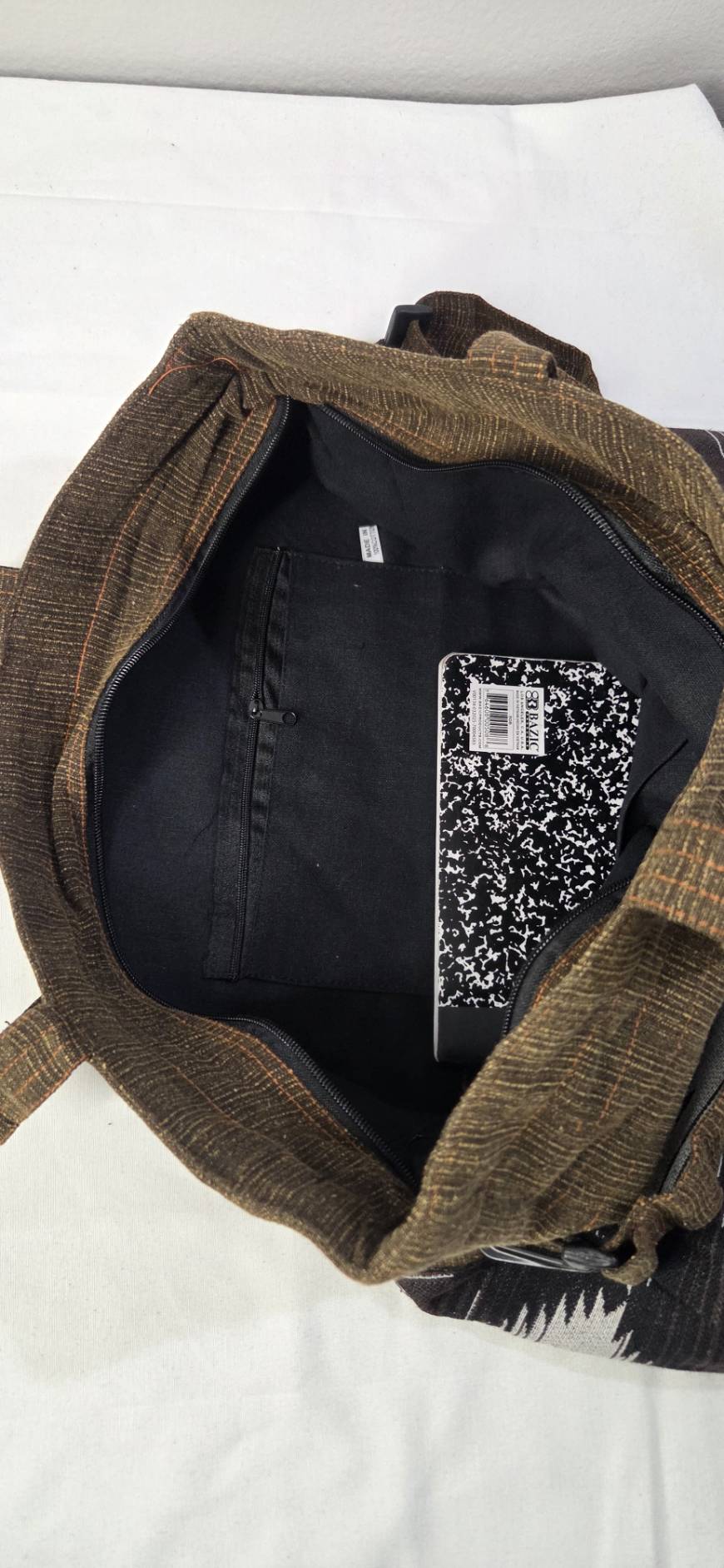Thai cotton boho tote bag ET-07 – dark brown body with bold black white aztec stripe woven panel, detachable strap, lifestyle hanging shot with ivy and basket