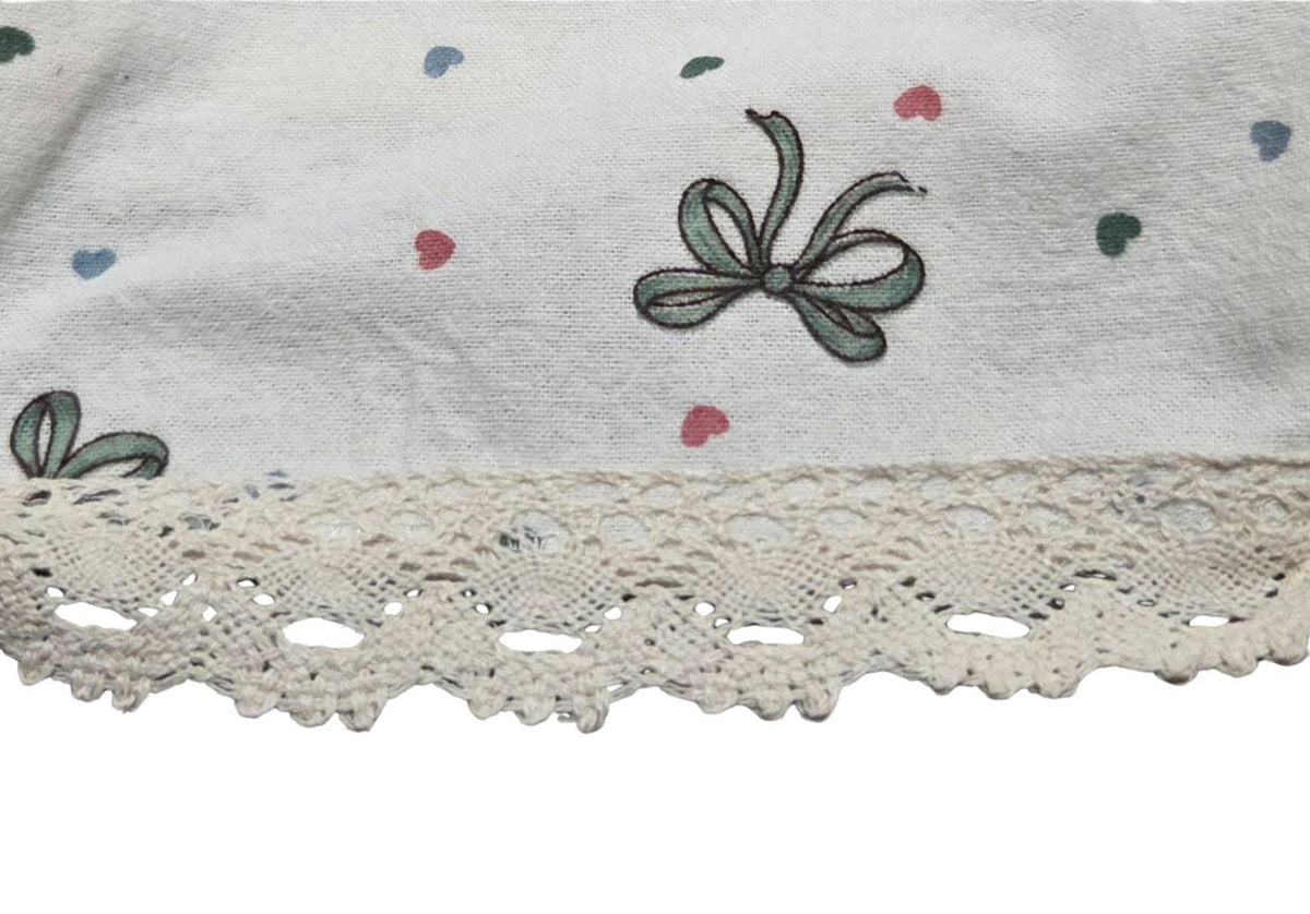 Close-up of LP-04 bow print pajama pants and cream lace hem