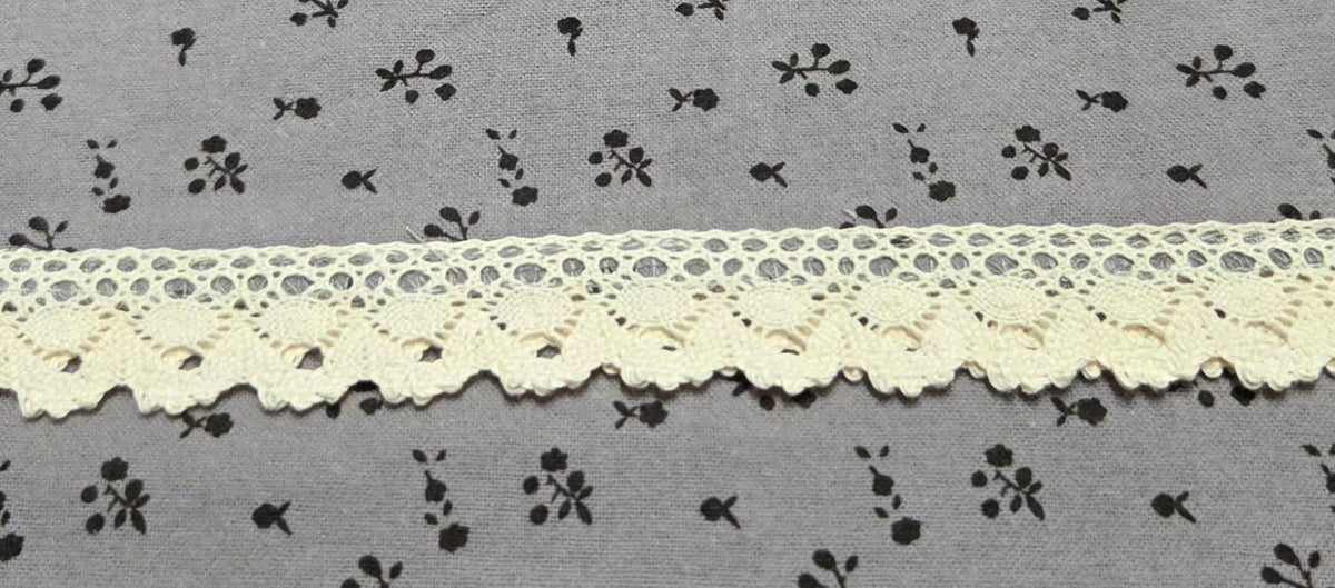Close-up of LP-07 dusty gray floral fabric and cream lace hem