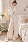 Model wearing LP-05 ivory teddy bear and pink bow straight-leg pajama pants