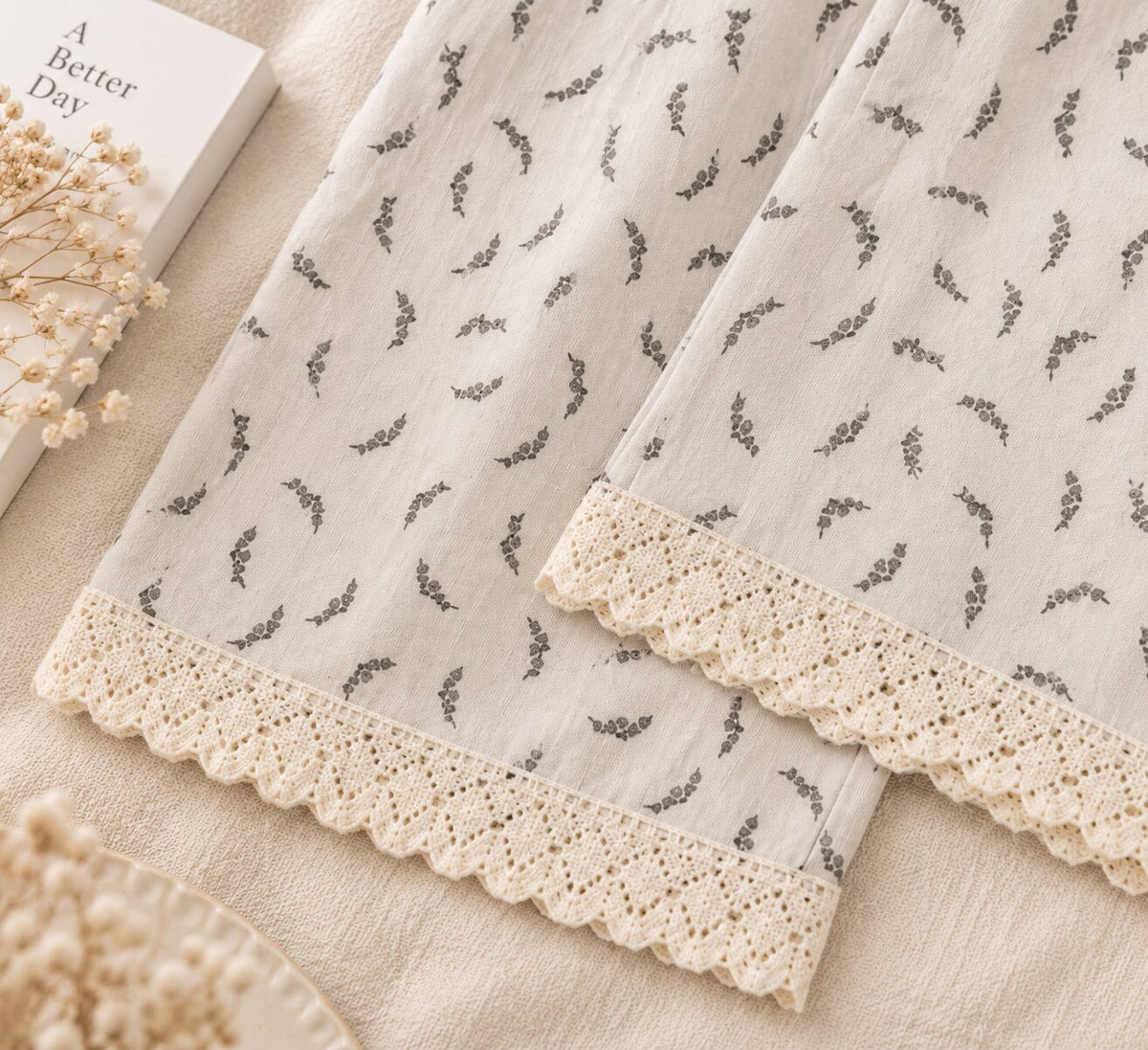Close-up of cream scalloped lace trim on LP-08 ivory pajama pants