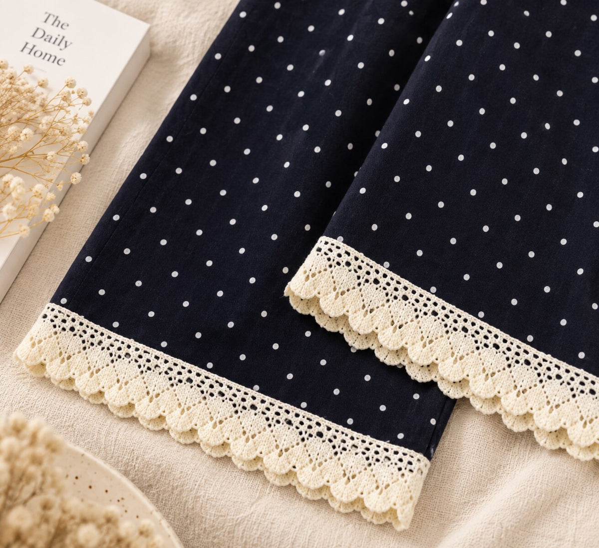 Close-up of cream scalloped lace trim on LP-09 black pajama pants