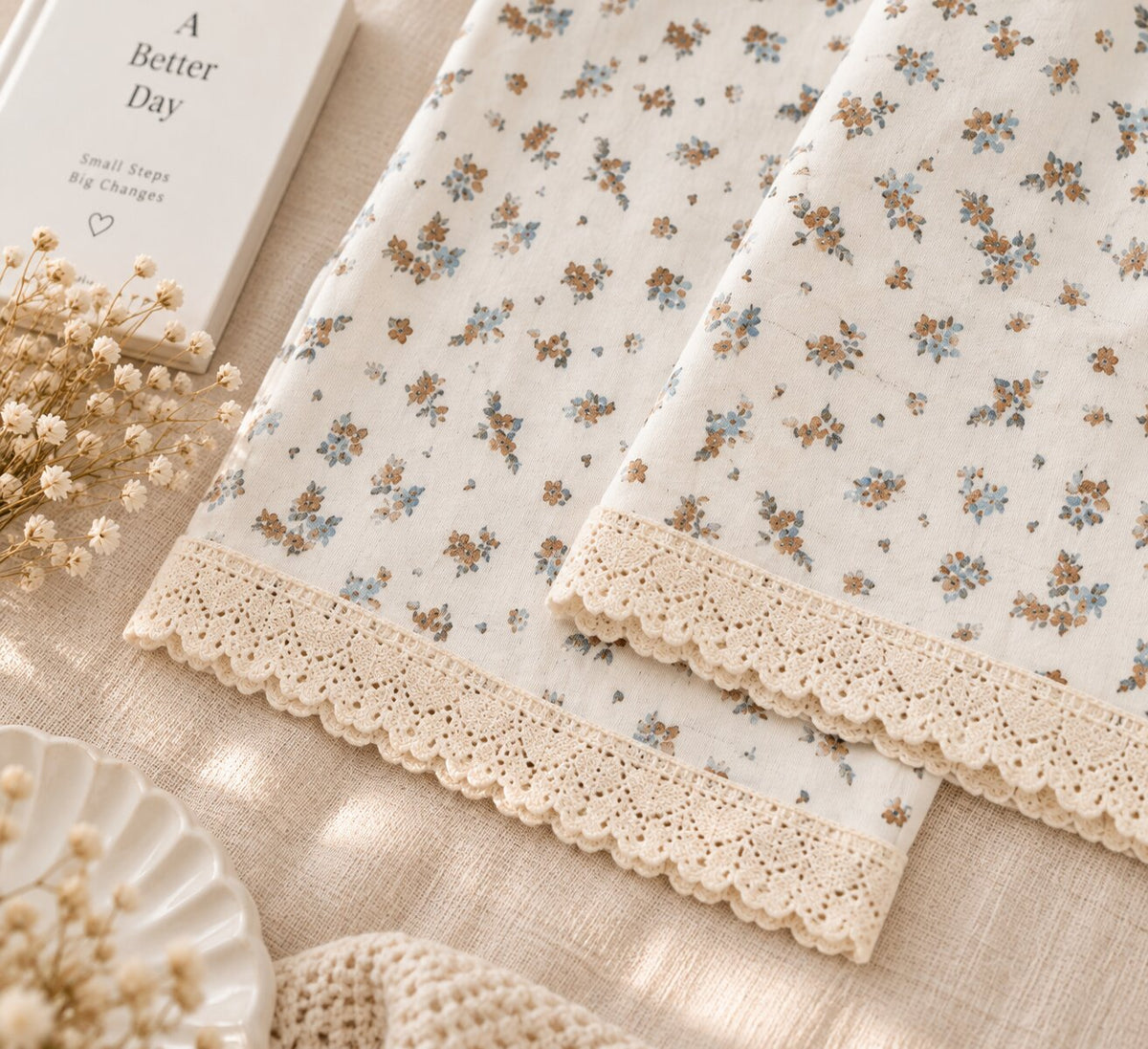 Close-up of brown and pale blue floral print with cream lace on LP-11 pajama pants
